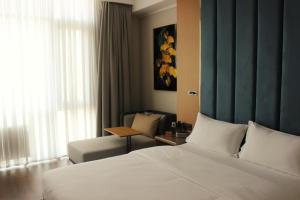a hotel room with a bed and a couch at Paziro Hotel in Dushanbe +8 photos