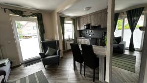 a kitchen and living room with a table and chairs at SONNENSEITE 2 in Laboe