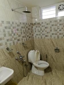 a bathroom with a toilet and a sink at Clintons Cove in Cochin