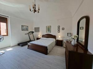 a bedroom with a bed and a dresser and a mirror at Su ciaccu in Nulvi