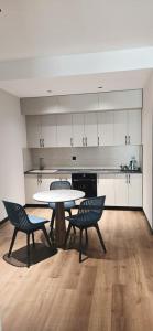 a kitchen with a table and two chairs in a room at Paziro Hotel in Dushanbe