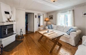a living room with a white couch and a coffee table at 2 Bedroom Lovely Home In Ödeshög in Ödeshög