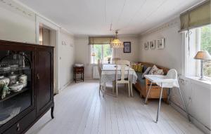 a kitchen and dining room with a table and chairs at 2 Bedroom Lovely Home In Ödeshög in Ödeshög