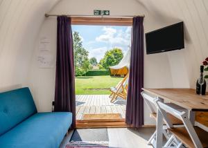 a living room with a door open to a yard at Apple Mount Retreat in Preston