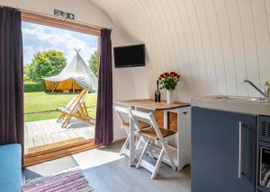 a kitchen with a table and a view of a tent at Apple Mount Retreat in Preston