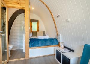 a small room with a bed and a bathroom at Apple Mount Retreat in Preston