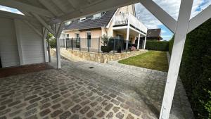 a house with a stone walkway in front of a house at SONNENSEITE 2 in Laboe