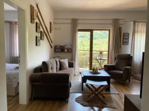 a living room with a couch and a chair and a table at Moun2 in Mavrovo