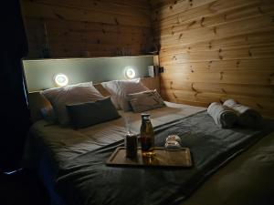 a bed with a tray with a drink on it at L'Escapade du Puy in Saint-Amand-sur-Sèvre