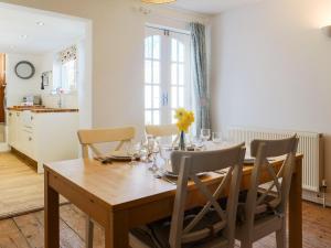 a dining room with a wooden table and chairs at Loreto in Freshwater