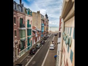 a view from a balcony of a street with cars at VILLA treize quartier balnéaire in Mers-les-Bains