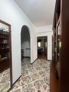 a hallway with a stone floor and an archway at La Terrazza sul Trebbia in Ottone