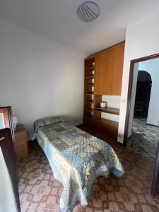 a bedroom with a bed and a dresser and a mirror at La Terrazza sul Trebbia in Ottone