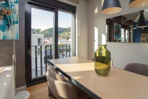 a dining room with a table with chairs and a vase on it at Elefante 10 - Donja Lastva in Donja Lastva