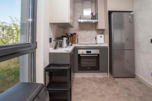 a small kitchen with a stainless steel refrigerator at Elefante 10 - Donja Lastva in Donja Lastva