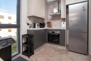 a kitchen with a stainless steel refrigerator and a window at Elefante 10 - Donja Lastva in Donja Lastva