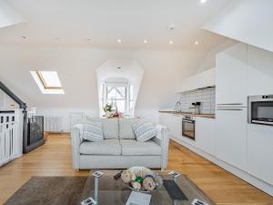 a living room with a couch and a kitchen at Killantrae Burn in Port William