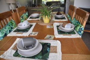 a table with plates and hats on top of it at Willow View Streamside Retreat near Kynren Durham in Newton Aycliffe
