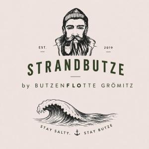 a drawing of a man with a beard and a wave at STRANDBUTZE by BUTZENFLOTTE Grömitz - Beach Vibes & 100 Meter zum Meer in Grömitz