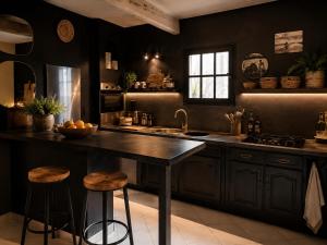 a kitchen with black walls and a large island with stools at La maison perchee in Aigues-Mortes