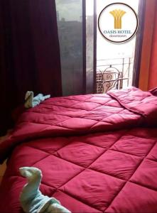 a bed with a pink comforter in a room at AL Waha Cairo Hotel in Cairo