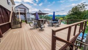 a wooden deck with a table and chairs on it at Cove Manor in Maynardville