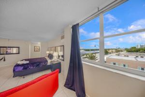 a bedroom with a bed and a large window at RoofTop Resort - Hollywood Beach, Florida in Hollywood