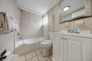 a bathroom with a white toilet and a sink at RoofTop Resort - Hollywood Beach, Florida in Hollywood +14 photos