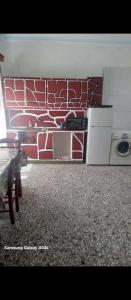 a living room with a red and white wall at Mary Mary! in Agios Kirykos