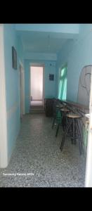 a room with tables and chairs in a room with a door at Mary Mary! in Agios Kirykos