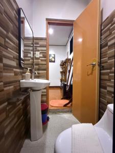 a bathroom with a sink and a toilet and a mirror at Fabregas Beach Cottages in El Nido +272 photos