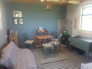 a bedroom with a table and chairs and a desk at Sleep4GlampingTent-NearTralee-Countryside in Tralee