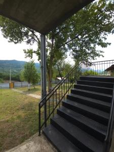 a set of stairs leading up to a house at Guesthouse Hikari Racha in Bostana