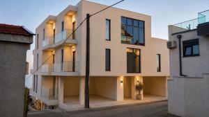 an apartment building with a glass facade at Vila Maxim in Marovići