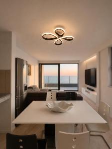 a kitchen and living room with a ceiling fan at Vila Maxim in Marovići