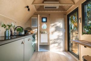 an interior view of a kitchen in a tiny house at La Tiny sous les pins in Noves +44 photos
