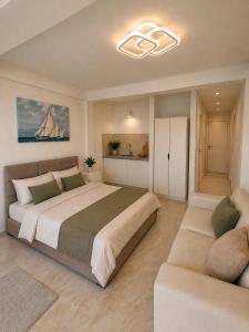 a bedroom with a large bed and a couch at Vila Maxim in Marovići