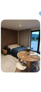 a bedroom with a bed and a table and a bed at La PETITE MAISON in Gourdan-Polignan