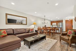 a living room with a couch and a table at Powderhorn Suite in Solitude