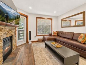 a living room with a couch and a fireplace at Powderhorn Suite in Solitude