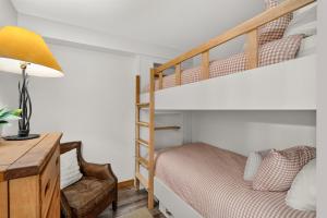 a bedroom with a bunk bed and a desk with a lamp at Powderhorn Suite in Solitude +34 photos