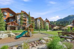 a playground in front of a resort with a slide at Powderhorn Suite in Solitude