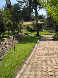 a brick walkway with a street light next to a house at Njaro Haven in Weru Weru