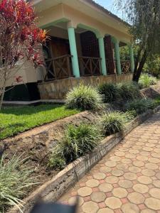 a house with a porch with plants in front of it at Njaro Haven in Weru Weru