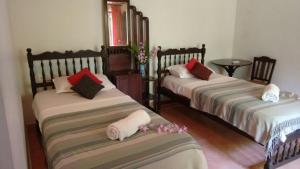 a room with two beds with towels on them at Vembanad House Boutique Back Water Retreat in Alleppey