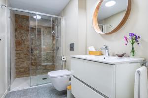 a bathroom with a shower and a toilet and a sink at La Casa del Miracle, hostal in Balaguer +34 photos
