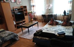 a living room with a couch and a coffee table at Tosmare Apartament in Liepāja