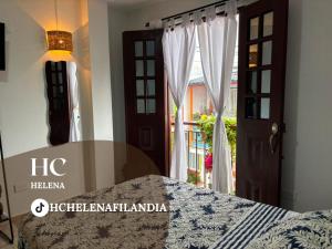 a bedroom with a bed and a door with a window at HC Helena in Filandia