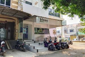 a group of motorcycles parked in front of a building at RedDoorz at Jatisampurna 