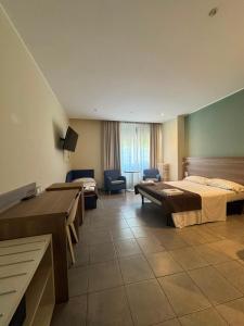 a hotel room with two beds and a television at Hotel Vintage Milano Centrale in Milan